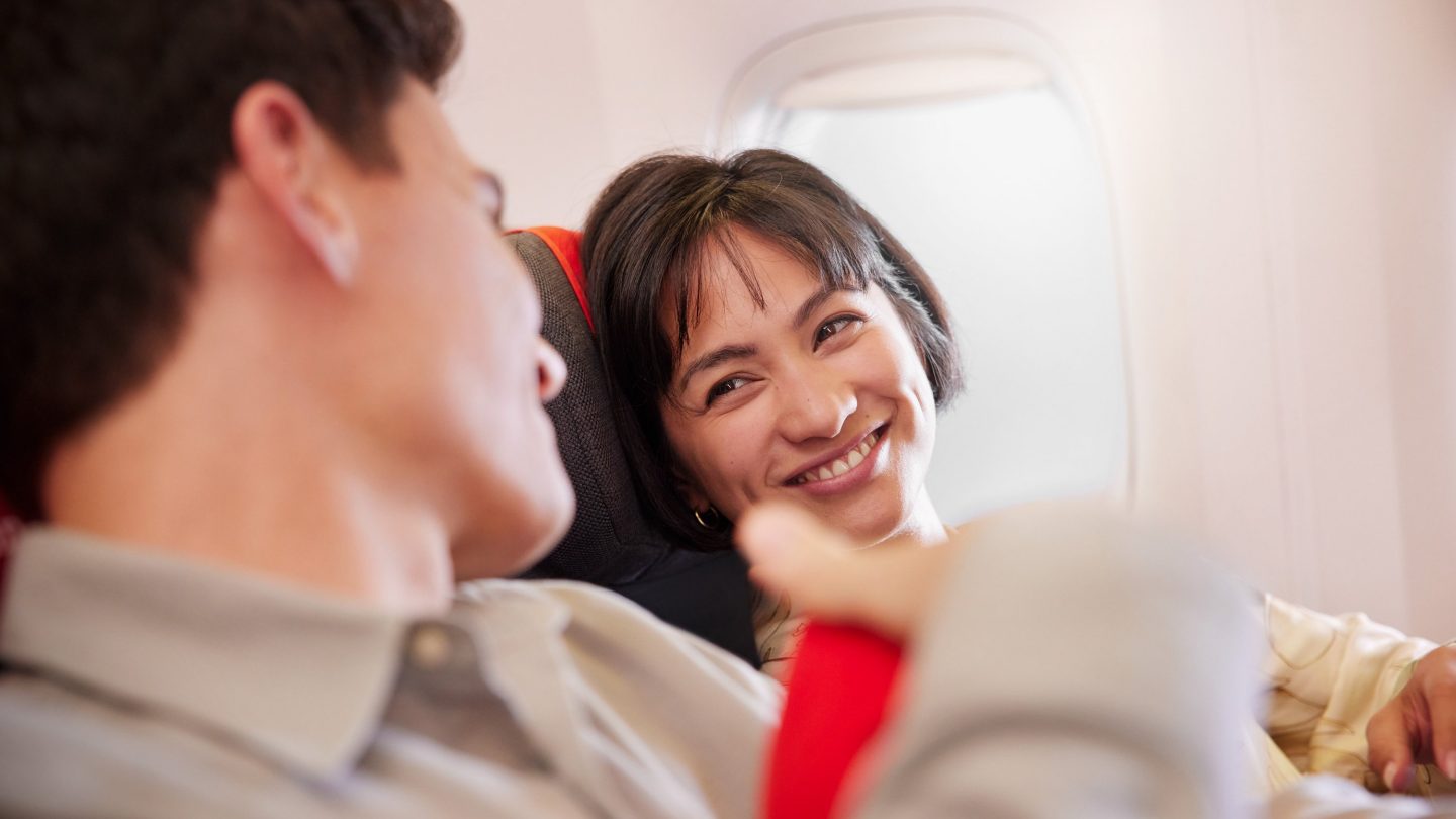 Smiling couple on an airplane.