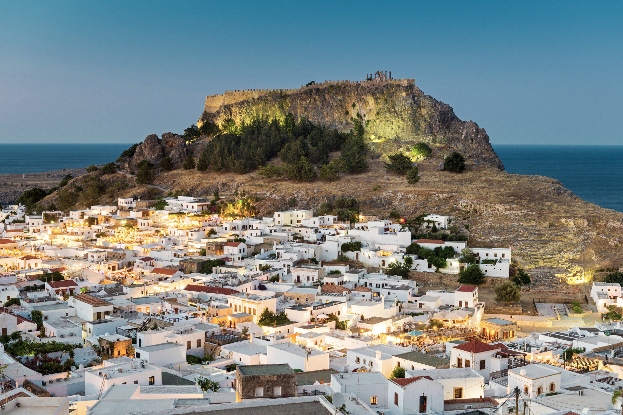 White rooftops of Lindos with the Acropolis of Lindos, Rhodes, Dodecanese, Greek Islands, Greece, Europe