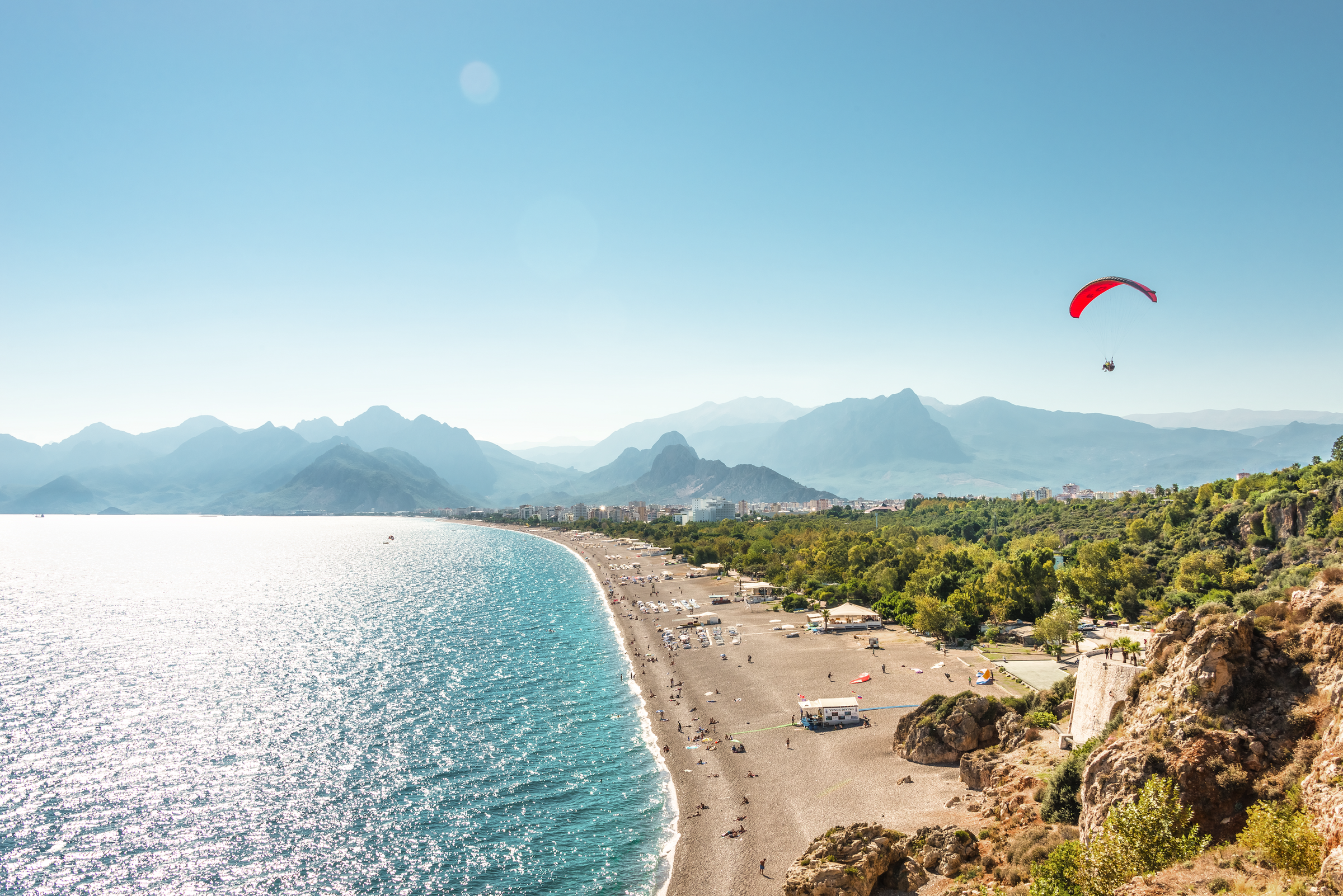 Panoramic bird view of Antalya and Mediterranean seacoast and beach with a paraglider, Antalya, Turkey, Autumn