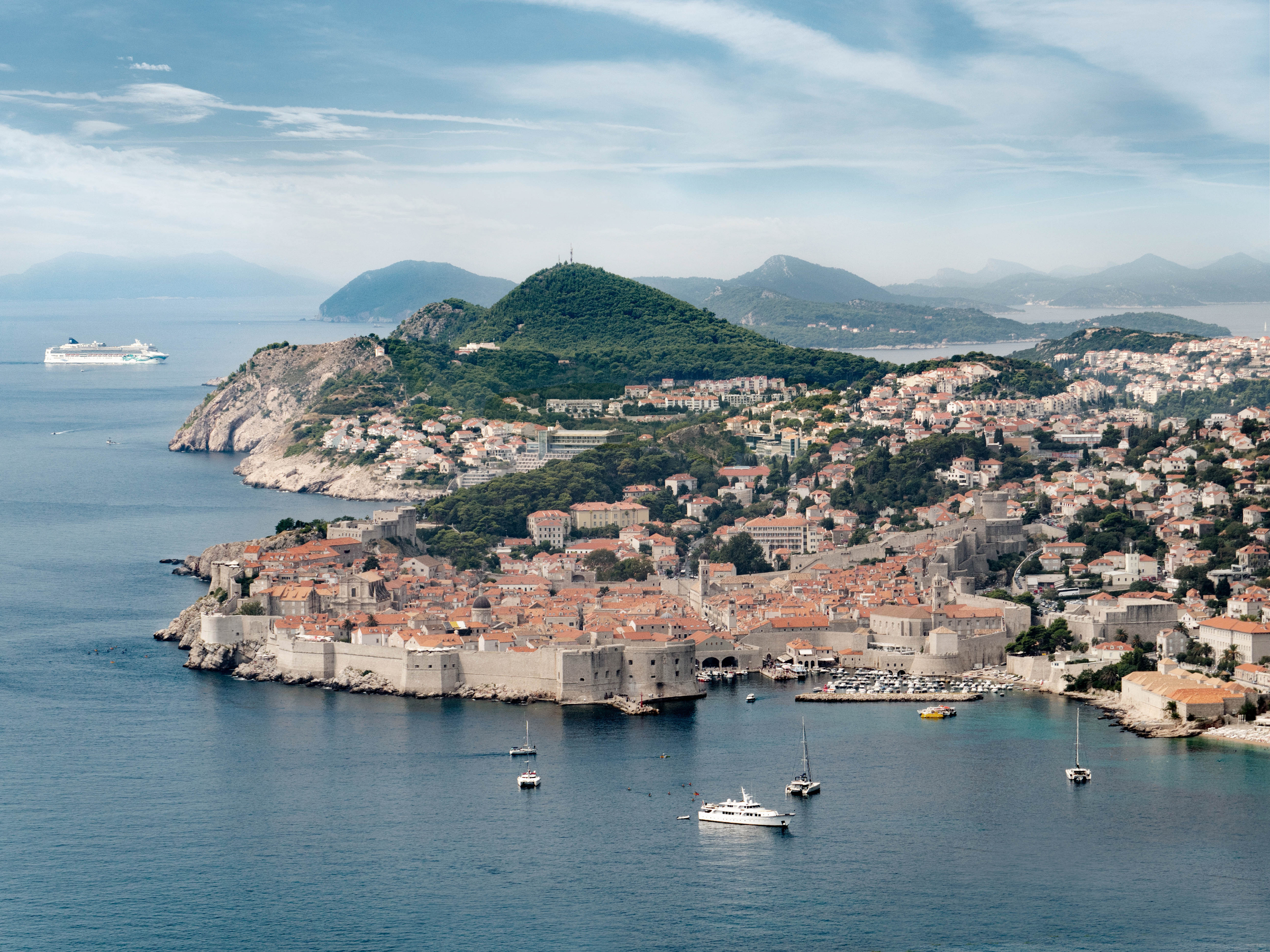 Dubrovnik is a historic Croatian city on the Adriatic Sea, in the region of Dalmatia. A UNESCO World Heritage Site, it is one of the most prominent tourist destinations in the Mediterranean Sea, a busy seaport and the centre of Dubrovnik-Neretva County. The prosperity and grandeur of the city was historically based on maritime trade; although it was demilitarised in the 1970s, it was shelled during the 1991 war following the breakup of the former Yugoslavia. Today, the beautiful Old Town is surrounded by stunningly preserved defensive walls, and contains many notable historic churches, museums, palaces and monasteries. This historic legacy, combines with a beautiful climate and crystalline surrounding seas, is leading to its inundation by tourism. Its popularity has been further fostered by its use as a prominent filming location for Game of Thrones, where it features as parts of Kings Landing.