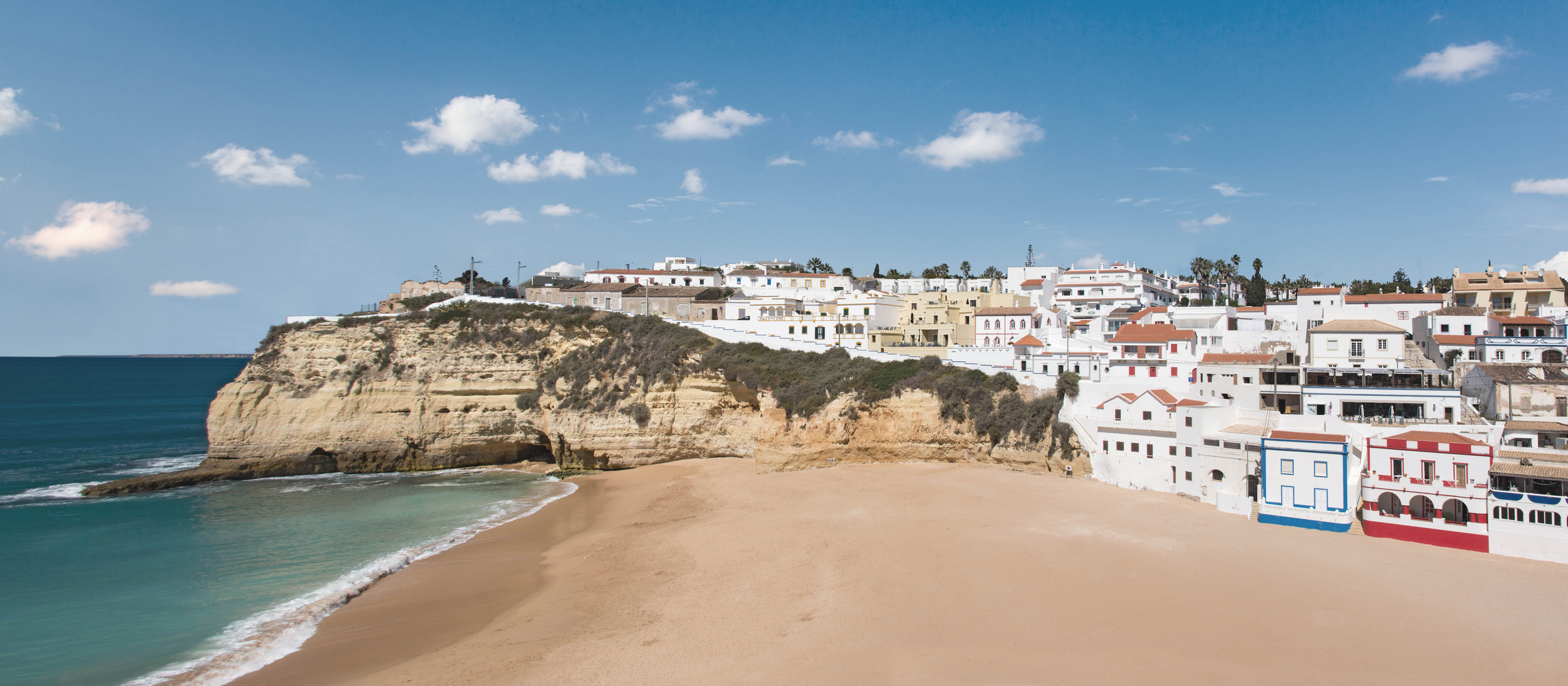 Panoramic view of the village and beach of Carvoeiro on the rocky coastline of the Algarve, Portugal.