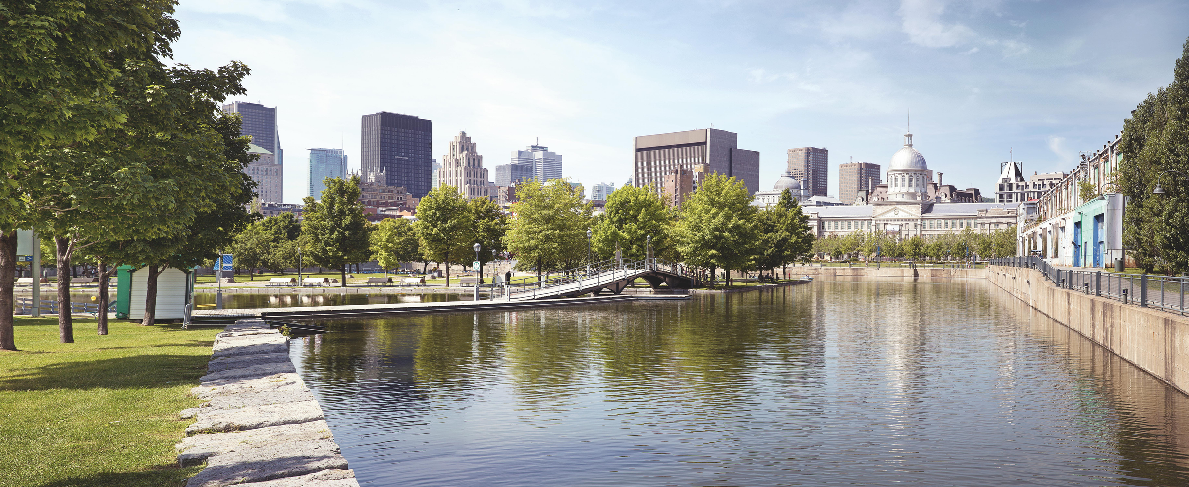 Summer panorama of downtown Montreal viewed from the park, showing the old Bonsecours Market building, which was the public city market for over 100 years.