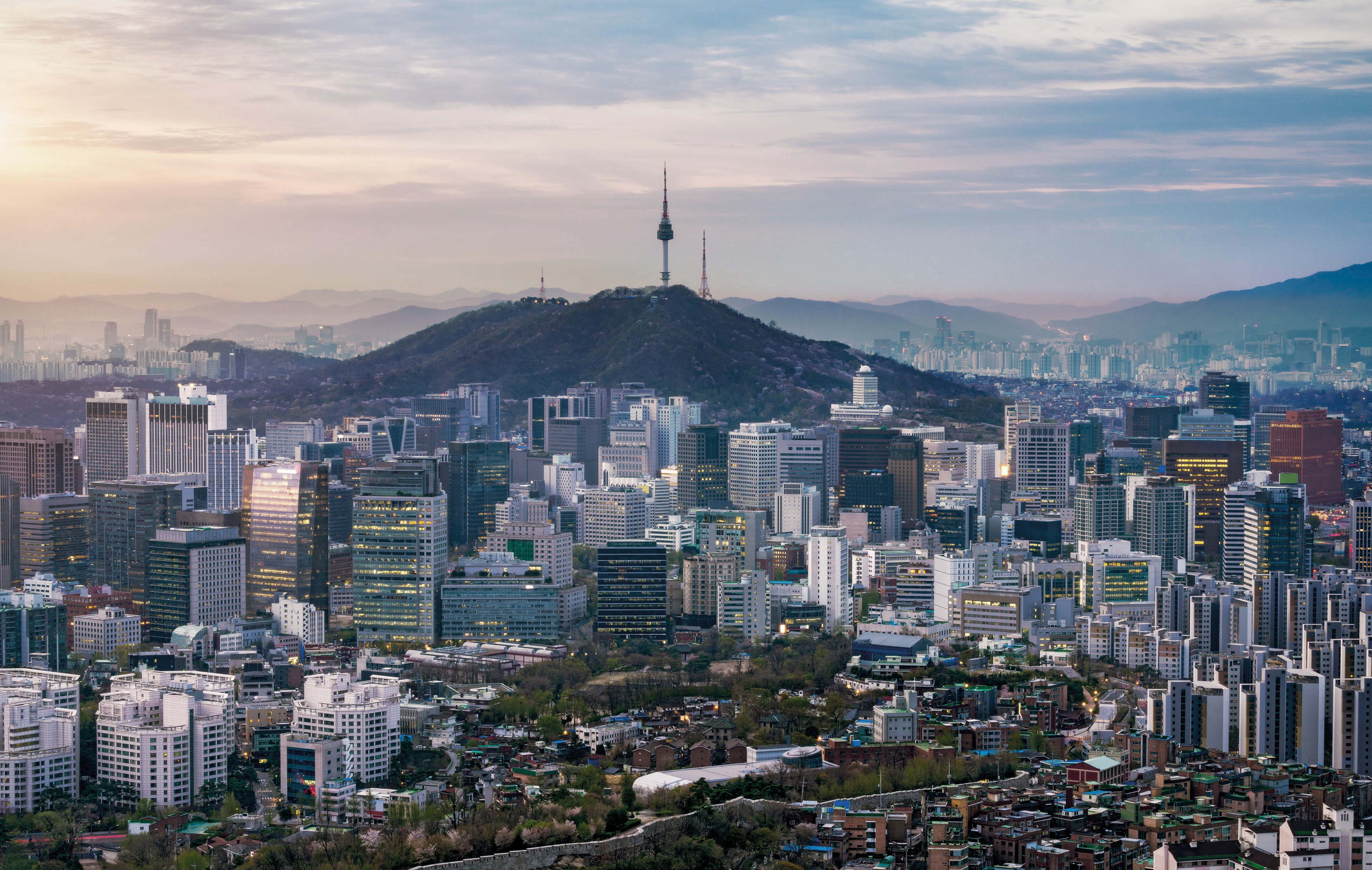 Sunrise scene of Seoul downtown city skyline, Aerial view of N Seoul Tower at Namsan Park in twilight sky in morning. The best viewpoint and trekking from inwangsan mountain in Seoul city, South Korea