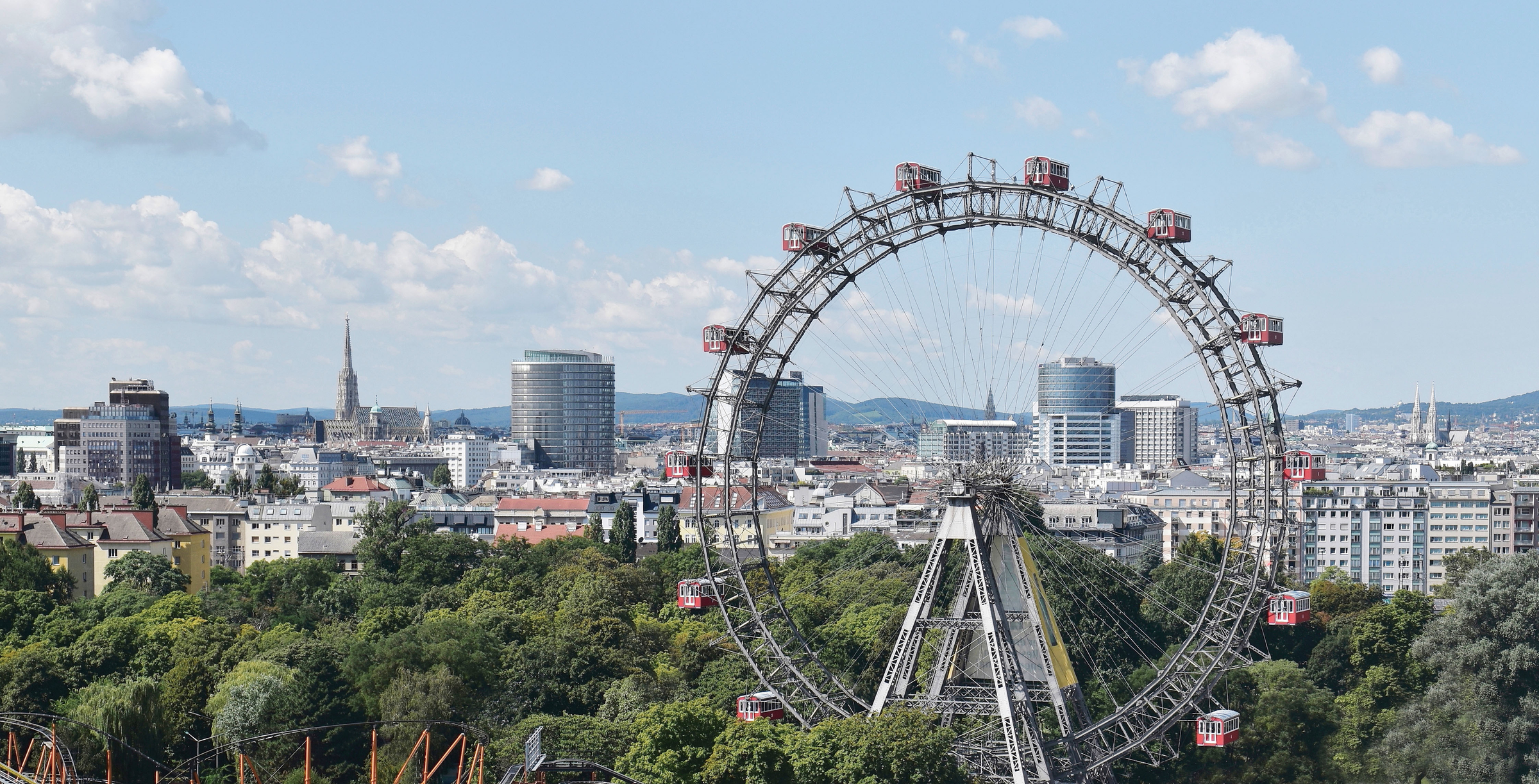 Panoramic view of Vienna, capital city of Austria, Europe. Ferris Wheel in Prater Entertainment Park, St. Stephen's Cathedral in the background