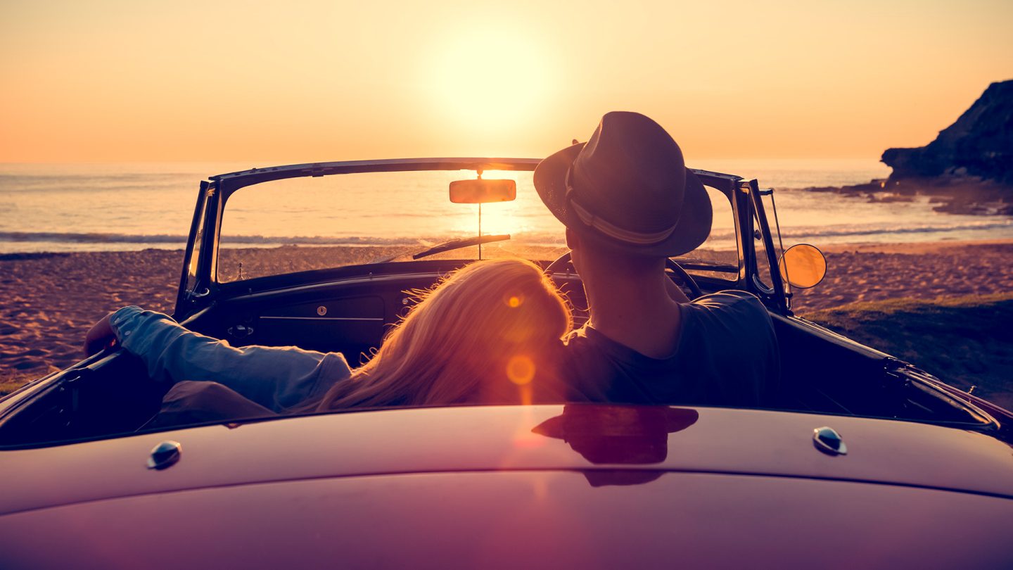 Couple sitting in a car at the beach