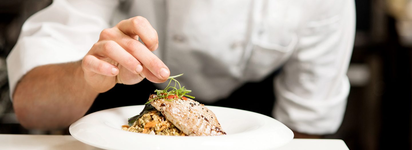 A cook prepares a menu