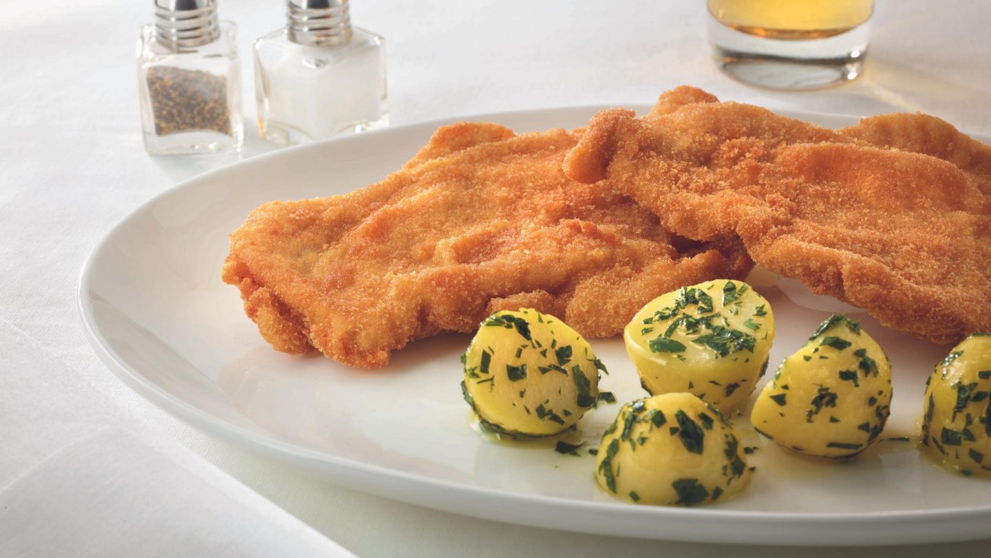 A Wiener Schnitzel with parsley potatoes.