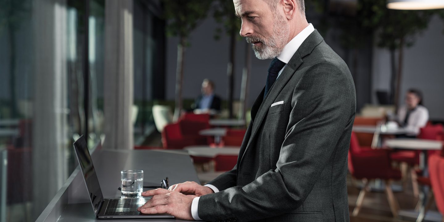 Businessman using laptop in Austrian lounge