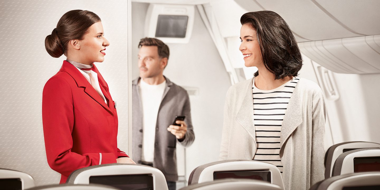 A passenger talking to a crew member on board