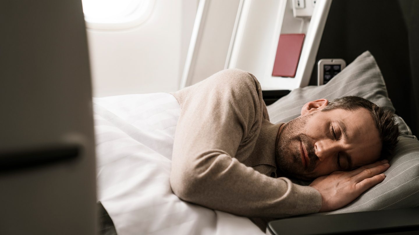 A passenger sleeps during the flight