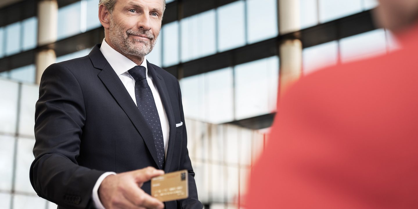 A man paying at the airport with his credit card